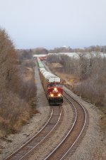 CP 8065 approaches westbound with 199 stretched out through the wetlands behind it